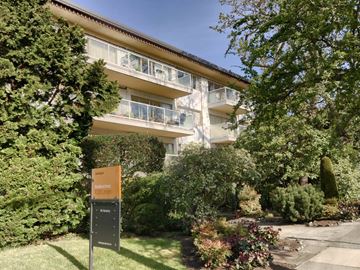 Victoria apartment for rent - A sign in front of a building with a balcony.