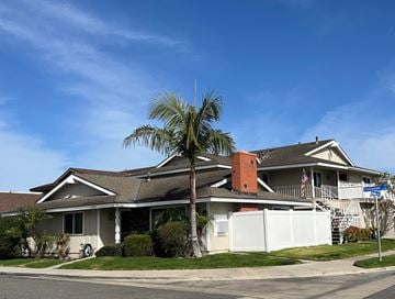 Huntington Beach apartment for rent - A house with a palm tree in front.