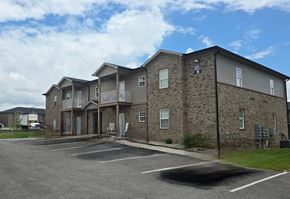 Bowling Green apartment for rent - A large building with a parking lot in front of it.