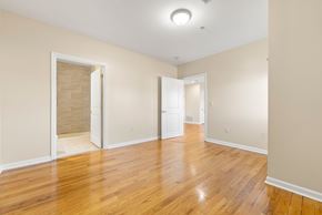 Union City apartment for rent - A room with wooden floors and white walls.