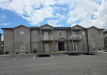Bowling Green apartment for rent - A row of houses with a parking lot in front.