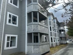 Bedford apartment for rent - A grey building with a lattice design on the balconies.