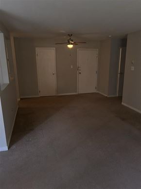 Bedford apartment for rent - A room with a ceiling fan and three doors.