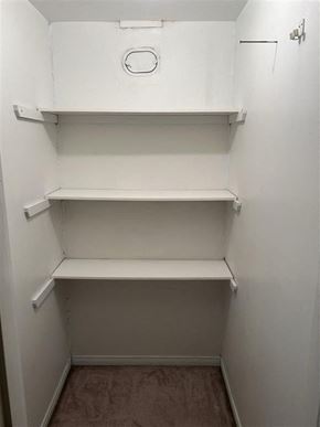 Bedford apartment for rent - A small, empty, white pantry with three shelves.