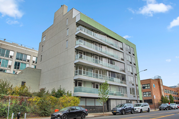 Brooklyn apartment for rent - A modern building with a green accent on the side.