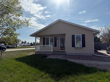 Kearney apartment for rent - A small house with a porch and a white fence.