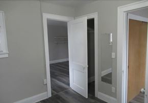 Bedford apartment for rent - A white door is open to a room with a wooden floor.