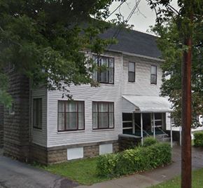 Bedford apartment for rent - A two-story house with a porch and a covered entrance.