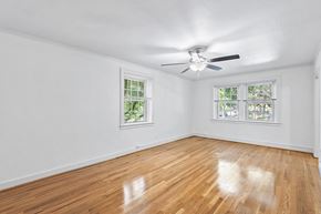 Denver apartment for rent - A room with a ceiling fan and two windows.