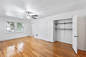 Denver apartment for rent - A room with a ceiling fan and a large open door.