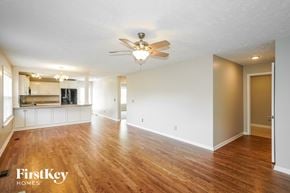 Antioch house for rent - A spacious room with wooden floors and a ceiling fan.