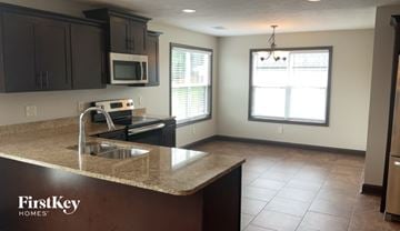 Clarksville house for rent - A kitchen with a sink, microwave, and oven.