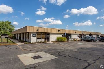 Huber Heights apartment for rent - A parking lot in front of a building with a white facade and a sign that says "BMW".