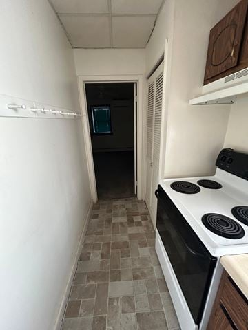 Laurys Station apartment for rent - A kitchen with a white stove top oven and a tiled floor.
