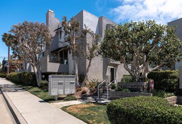 Hermosa Beach apartment for rent - A modern house with a grey exterior and a tree in front.