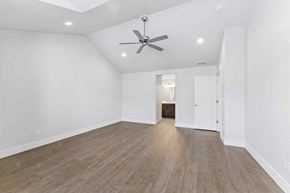 Bend apartment for rent - A room with a ceiling fan and wooden flooring.