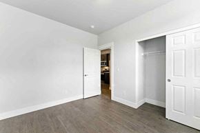 Bend apartment for rent - A room with white walls and a wooden floor.