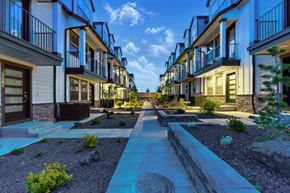 Bend apartment for rent - A row of modern townhouses with a sidewalk in front.
