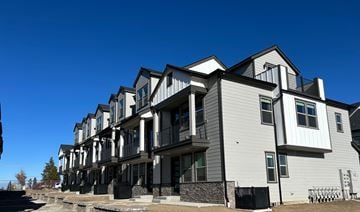 Bend apartment for rent - A row of modern townhouses with balconies and black railings.