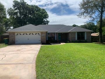 Crestview house for rent - A house with a grey roof and a white garage door.