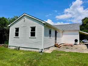 New Albany house for rent - A small white house with a grey roof and a grey shingled roof.