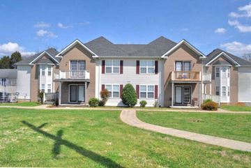 Bowling Green apartment for rent - A row of houses with a green lawn in front.