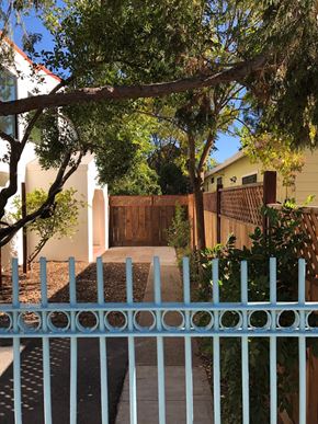Sonoma apartment for rent - A blue gate leads to a house with a brown fence.