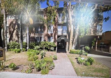 Toluca Lake apartment for rent - A building with the number 4624 on it is surrounded by trees and plants.