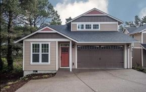 Lincoln City house for rent - A two-story house with a red door and a garage.