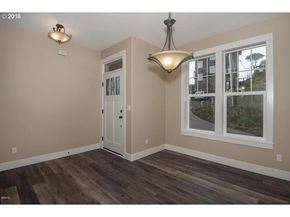 Lincoln City house for rent - A room with a white door and a window with a view of a building outside.