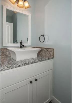 Lincoln City house for rent - A white sink with a mirror above it.
