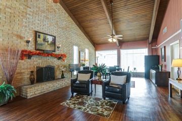 Baton Rouge apartment for rent - A living room with a fireplace and a painting on the wall.