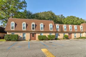 Baton Rouge apartment for rent - A building with a parking lot in front of it.