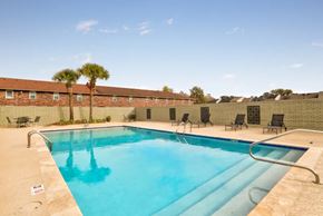 Baton Rouge apartment for rent - A swimming pool with a metal ladder and a metal railing.