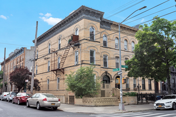 Brooklyn apartment for rent - A street view of a building with a fire escape.