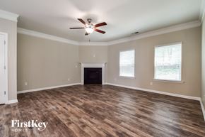 Canton house for rent - A spacious room with a fireplace and wood flooring.