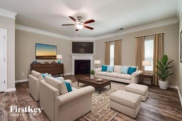Canton house for rent - A living room with a fireplace, couches, and a painting on the wall.