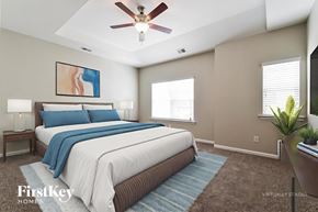 Canton house for rent - A bedroom with a large bed and a ceiling fan.