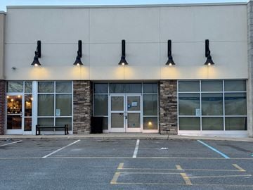 Newark apartment for rent - A building with a stone pillar and a glass door.