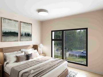 Elmsdale apartment for rent - A bedroom with a large bed and a view of a car and trees outside.
