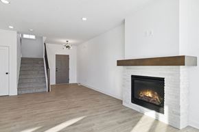 Lake Elmo house for rent - A modern living room with a fireplace and a staircase.