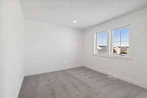 Lake Elmo house for rent - A room with a carpeted floor and a window showing a view of buildings outside.