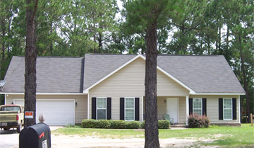 Statesboro house for rent - A house with a grey roof and a white garage door.