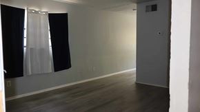 Crystal River house for rent - A room with a white door and a window with black curtains.