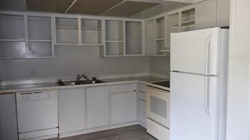 Crystal River house for rent - A white kitchen with a refrigerator on the right.