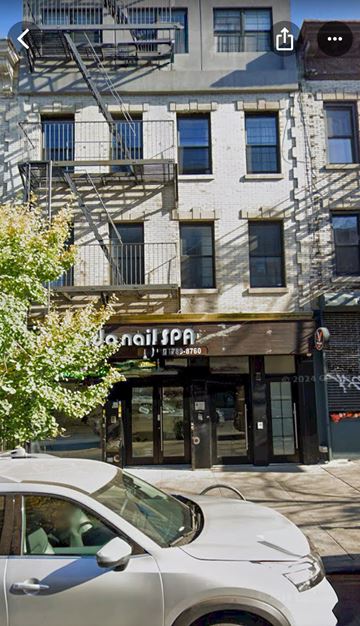 Brooklyn apartment for rent - A white car is parked in front of a building with a sign that reads "L'aile Spa".