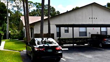 Fort Pierce house for rent - A black car is parked in front of a building.