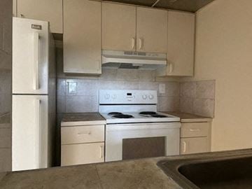 Cutler Bay apartment for rent - A kitchen with a white fridge, stove, and oven.