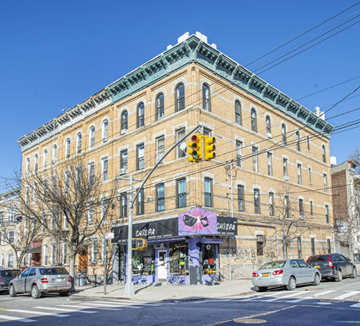 Brooklyn apartment for rent - A street view of a building with a pink mural on the front and a sign that says "Chas Pa Shisha".