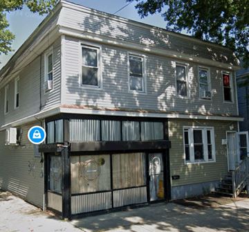 New Haven apartment for rent - A grey house with a blue sign on the front.
